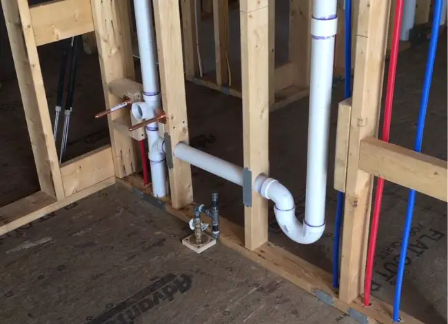 Installing the combination drain and vent system
