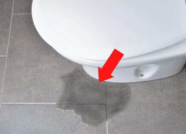 What are the signs of water damage under bathroom floor tile